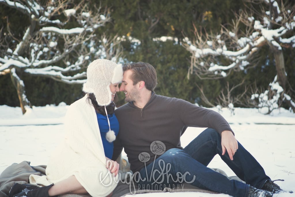 SugaShoc_Photography_Maternity_Photographer_Bucks County_Doylestown_PA_couple_snow_maternity_session_at_longwood_gardens_posed_sitting_with_hat