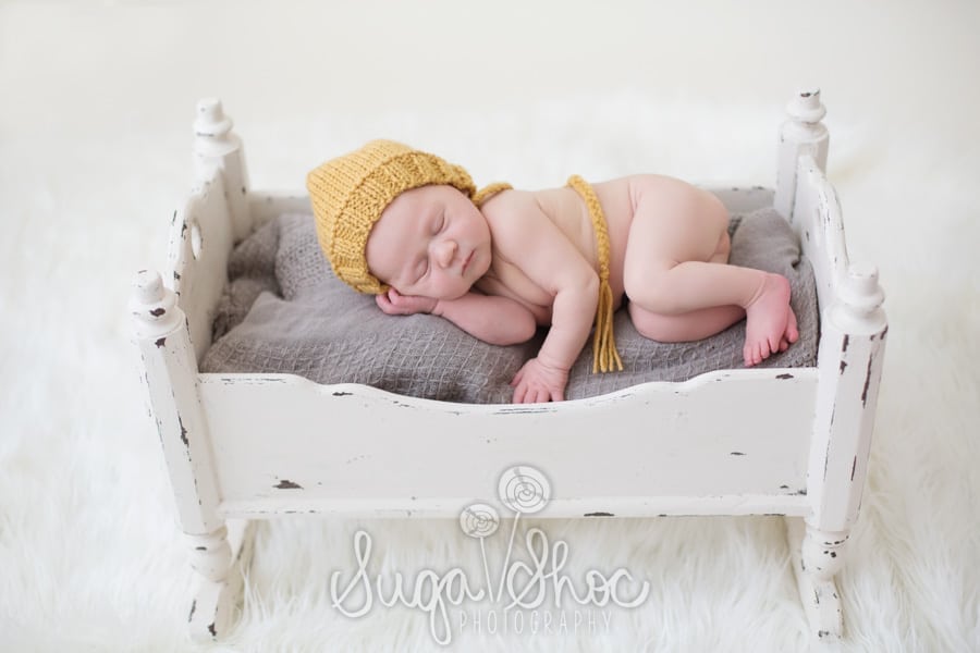 SugaShoc_Photography_Newborn_Photographer_Bucks_County_PA_Doylestown_newborn_in_bed_with_knitted_hat