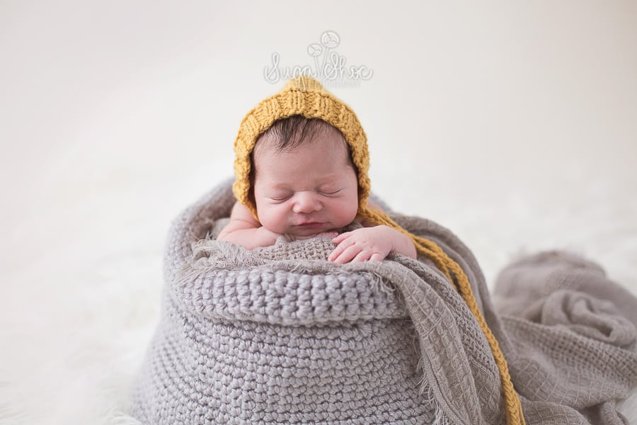 SugaShoc_Photography_Newborn_Photographer_Bucks_County_PA_Doylestown_PA_newborn_in_knitted_sack_mustard_yellow_hat_and_grey_sack