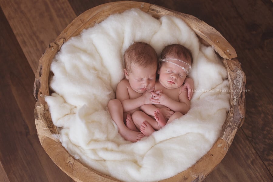 SugaShoc_Photography_Newborn_Twins_Photographer_Bucks_County_PA_Doylestown_PA_newborn_twin_pose_ideas_laying_side_by_side_fingers_interlocked_in_wool_puzzle_bowl