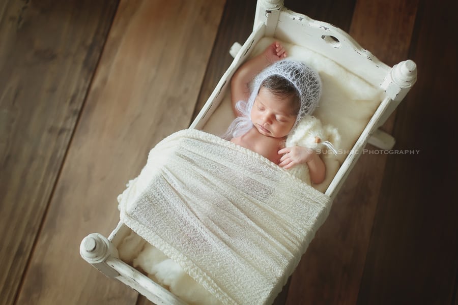 SugaShoc_Photography_Newborn_Photographer_Bucks_County_PA_Doylestown_PA_newborn_in_antique_wooden_bed_newborn_posing_ideas
