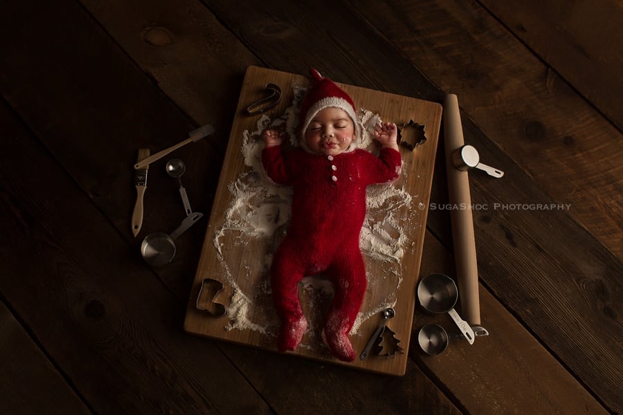SugaShoc_Photography_Newborn_Photographer_Bucks_County_PA_Doylestown_PA_newborn_elf_on_the_shelf_making_snow_angels_with_flour