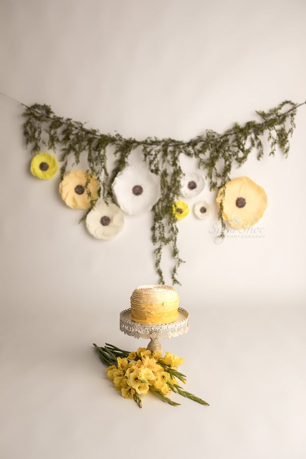 SugaShoc_Photography_Cake_Smash_Photographer_Bucks_County_PA_Doylestown_PA_Cream_and_yellow_smash_cake_yellow_flowers_flower_garland