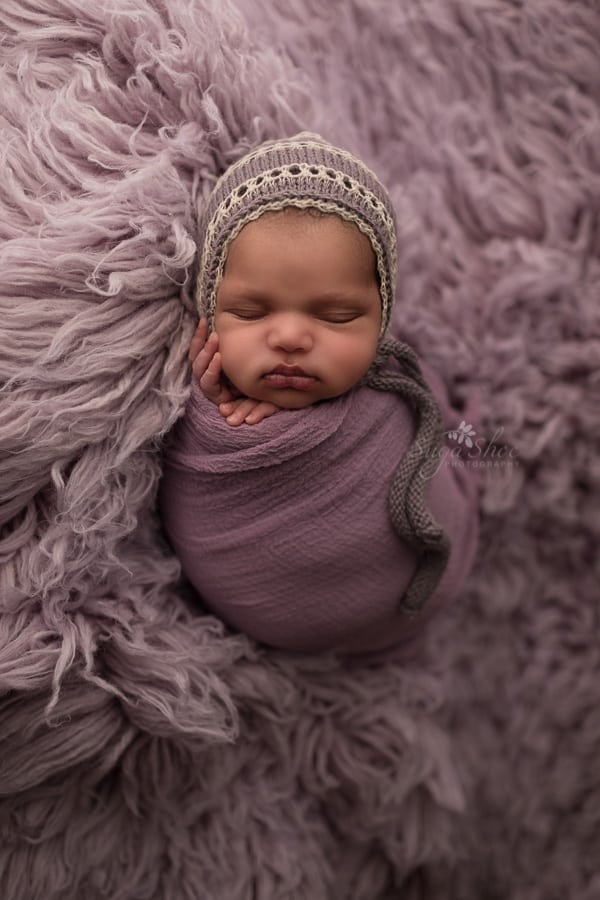 SugaShoc Photography Newborn Photographer Bucks County PA Doylestown PA laying down newborn potato sack pose on flokati