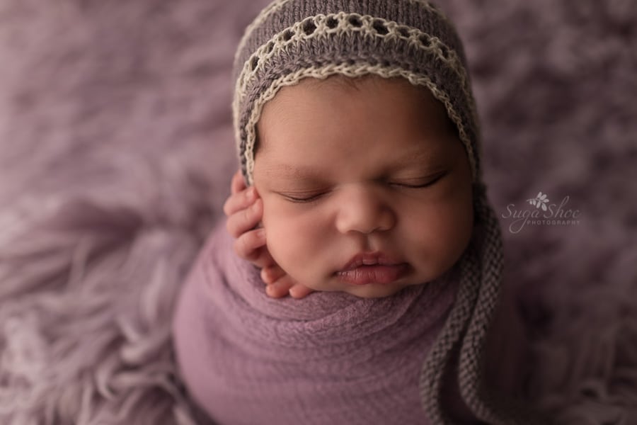 SugaShoc Photography Newborn Photographer Bucks County PA Doylestown PA close up newborn potato sack pose on flokati