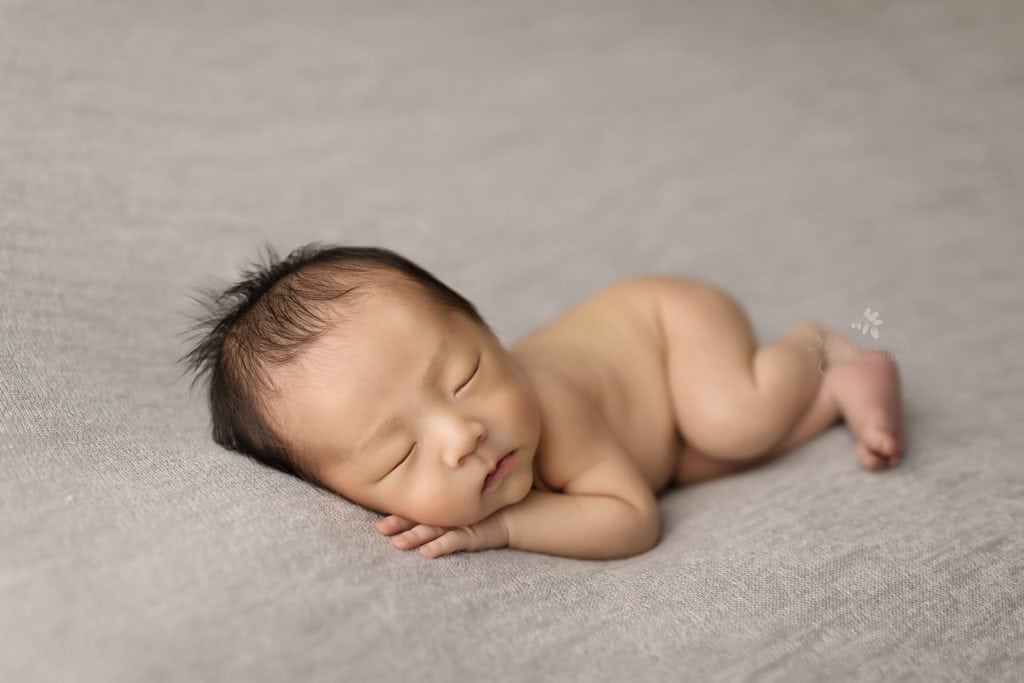SugaShoc Photography Newborn Photographer Bucks County PA Doylestown PA Neutral Tones Baby boy side laying shot on gray bedding