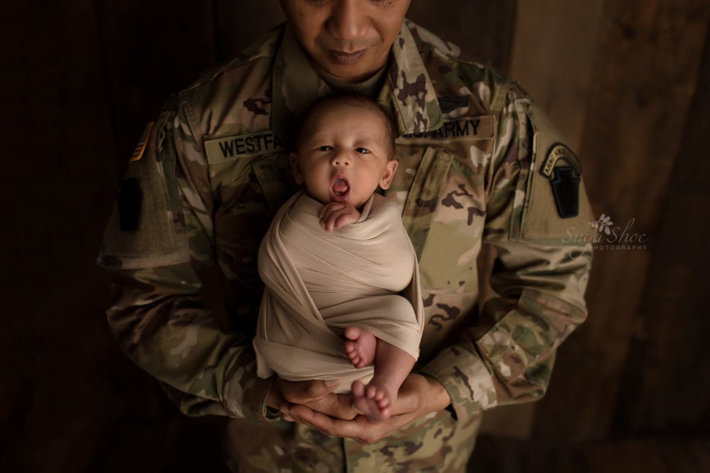 SugaShoc Photography Newborn Photographer Bucks County PA Doylestown PA Keeping Babies Asleep Baby boy awake wrapped in beige being held by father in Army uniform