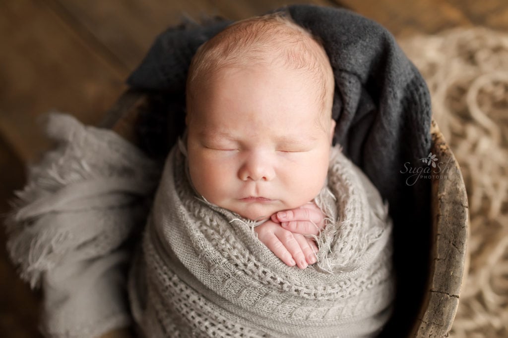 SugaShoc Photography Newborn Photographer Bucks County PA Doylestown PA Baby boy wrapped gray knit wrap sleeping in antique wooden bucket
