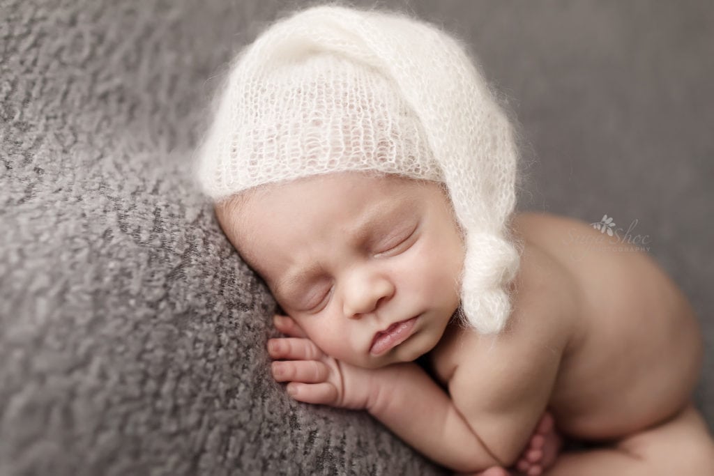 SugaShoc Photography Newborn Photographer Bucks County PA Doylestown PA Beckham Newborn Session baby sleeping wearing white knit hat on blue blanket