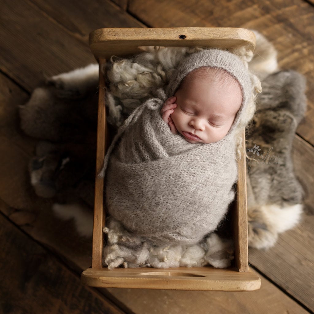 SugaShoc Photography Newborn Photographer Bucks County PA Doylestown PA Beckham Newborn Session baby sleeping wrapped gray wrap and matching hat in wooden bed