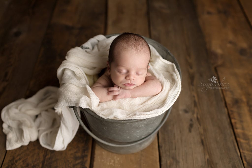 SugaShoc Photography Newborn Photographer Bucks County PA Doylestown PA Beckham Newborn Session baby sleeping in metal bucket with white throw