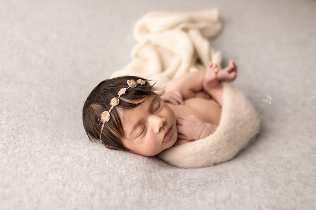 Newborn photography baby girl sleeping wearing floral headband