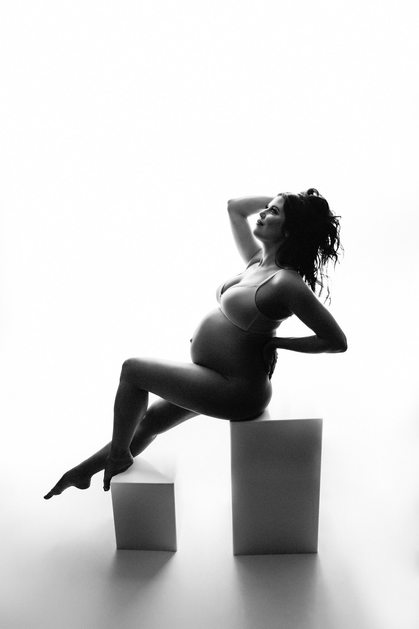 backlit black and white maternity on posing blocks