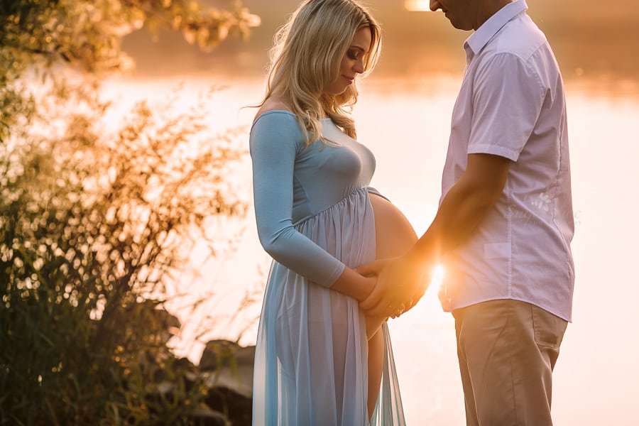 Sugashoc Photography Doylestown Maternity Photographer by lake with sunset on belly couple facing each other