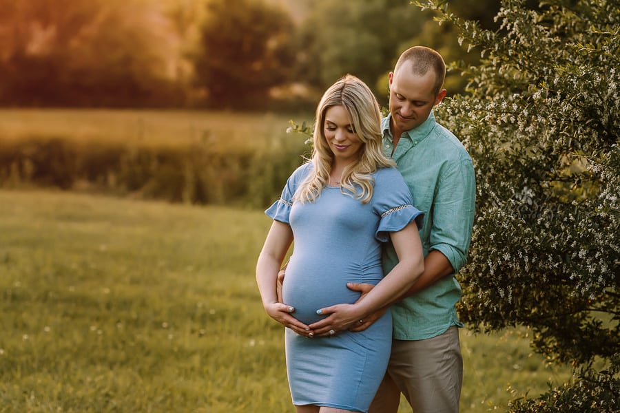 Sugashoc Photography Doylestown Maternity Photographer couple holding belly in field