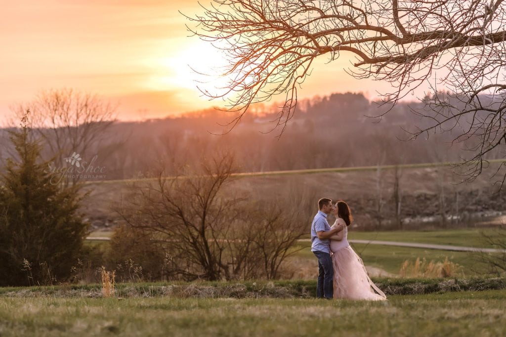Sugashoc Photography Doylestown Maternity Photographer couple kissing in field at sunset