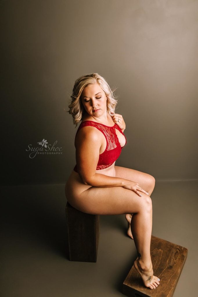 Anniversary Boudoir Sugashoc Photography sitting on wooden box wearing red lace top