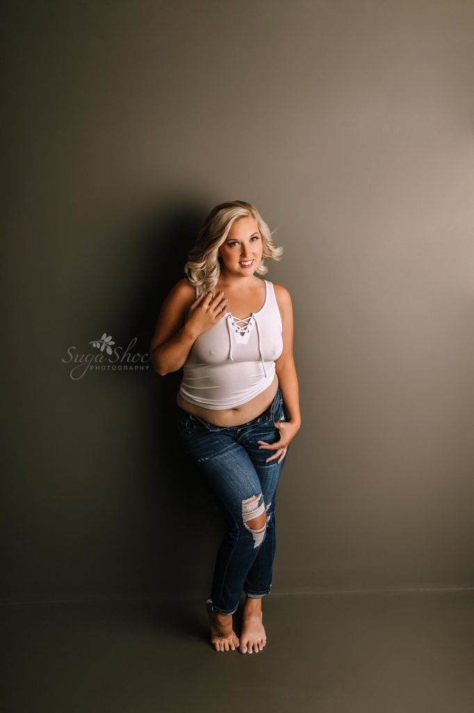 Anniversary Boudoir Sugashoc Photography standing against wall wearing white tank top and jeans