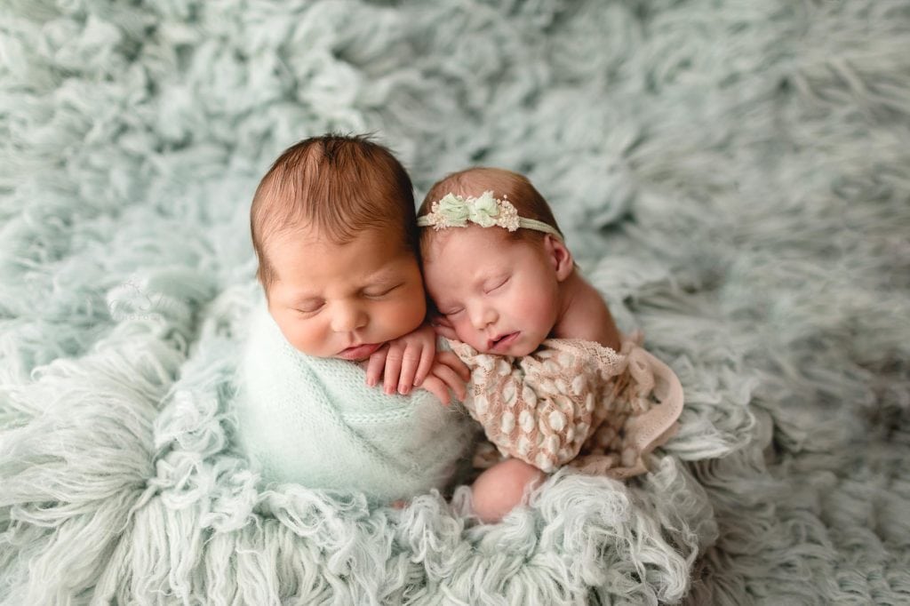 Sugashoc Photography Montgomery County Newborn Photographer twins cuddled boy wrapped in blue girl in lace outfit