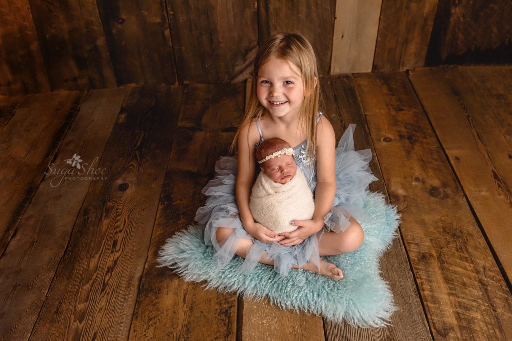 Sugashoc Photography Montgomery County Newborn Photographer big sister holding baby sister