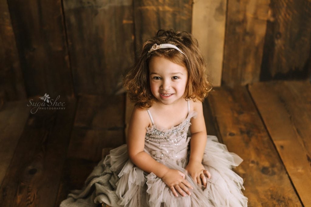 Sugashoc Photography Doylestown Children Photographer child pose girl in gray tulle dress smiling