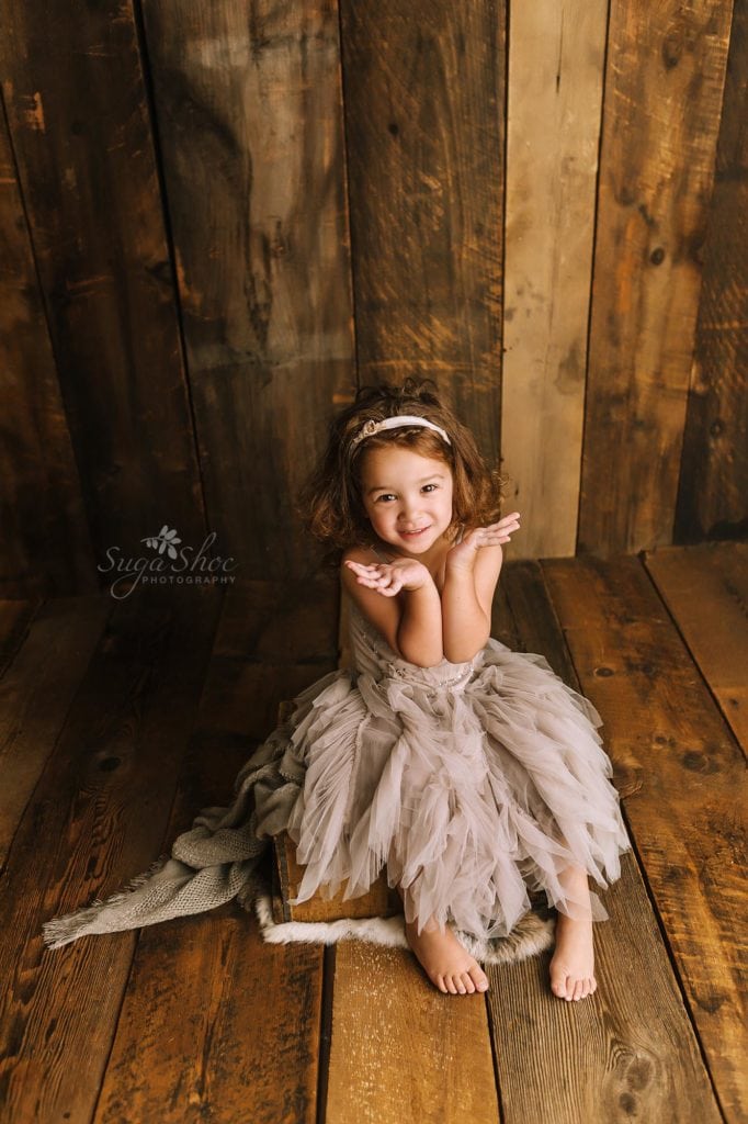 Sugashoc Photography Doylestown Children Photographer child pose with hands by face in gray tulle dress