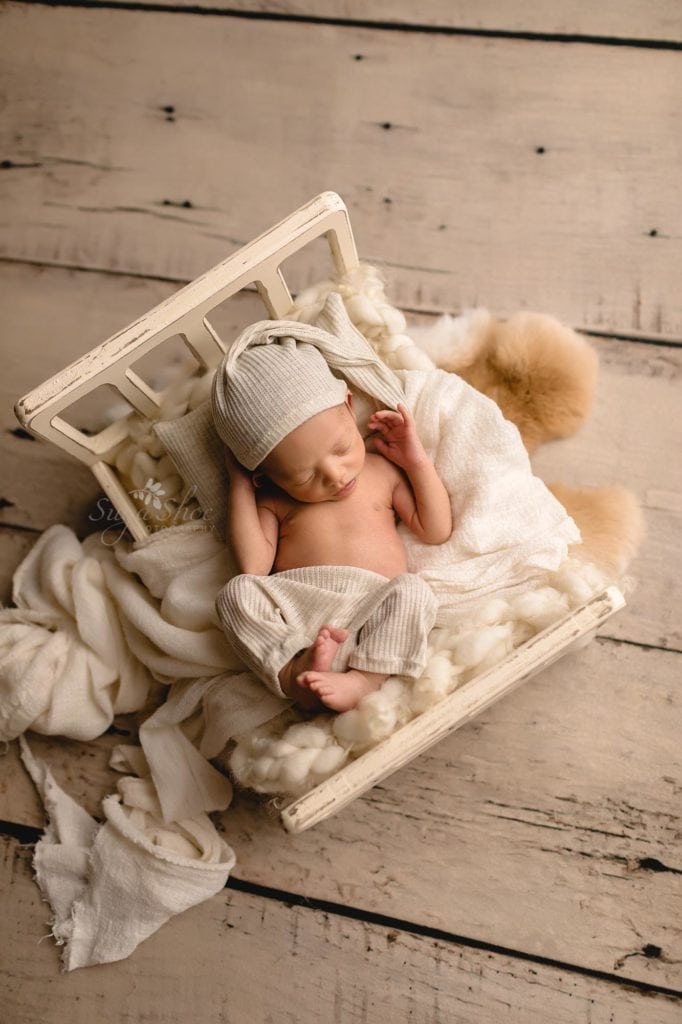 Fur Baby Newborn Session Sugashoc Photography baby boy sleeping in white bed