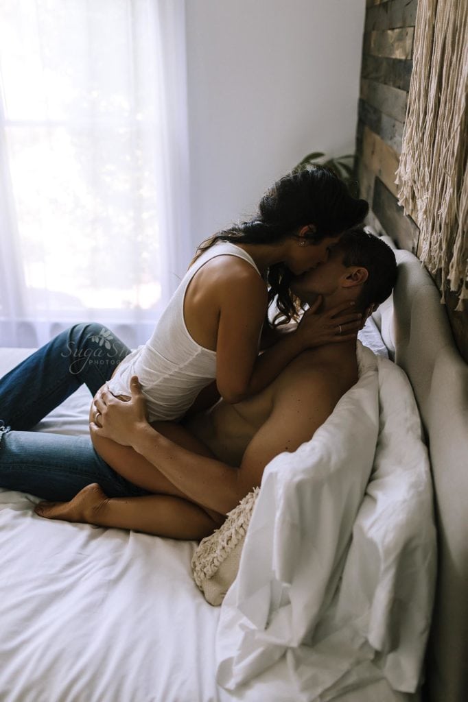 Philadelphia Couples Boudoir Photographer couple on bed kissing