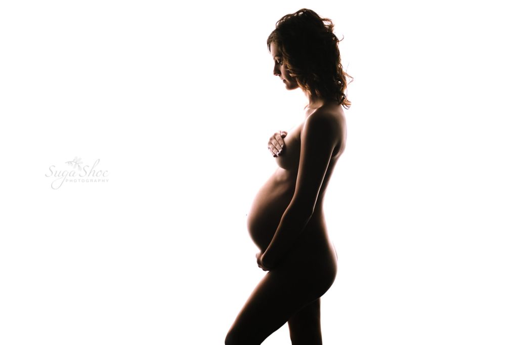 Philadelphia Maternity Boudoir Photographer SugaShoc Photography back lit silhouette of pregnant woman cradling belly
