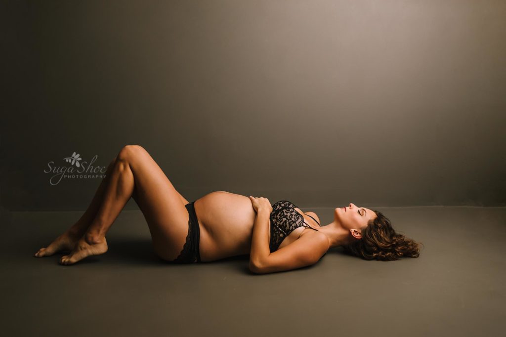 Philadelphia Maternity Boudoir Photographer SugaShoc Photography pregnant woman laying on floor wearing black bra and pantie