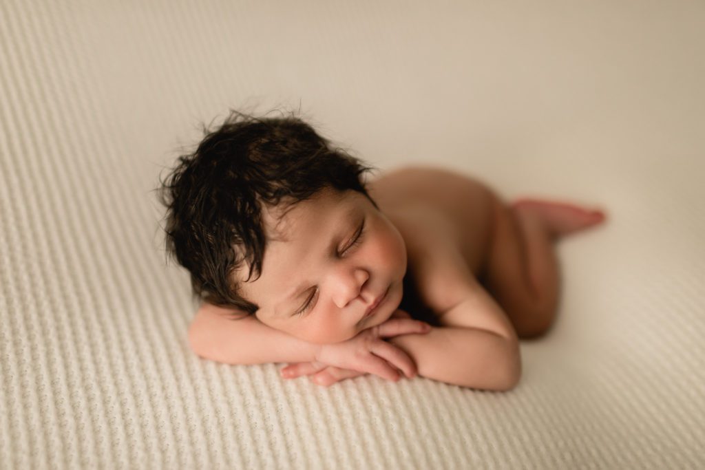 newborn photography near me bucks county pa, naked baby asleep on white blanket