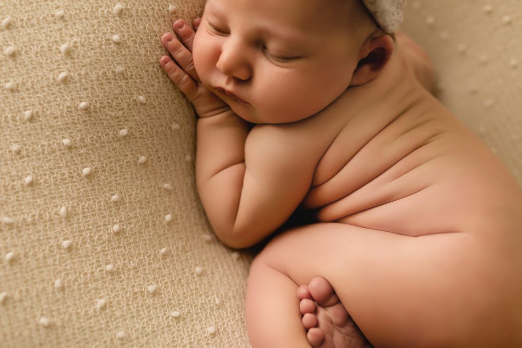 newborn photo session pennsylvania, naked baby asleep on textured fabric