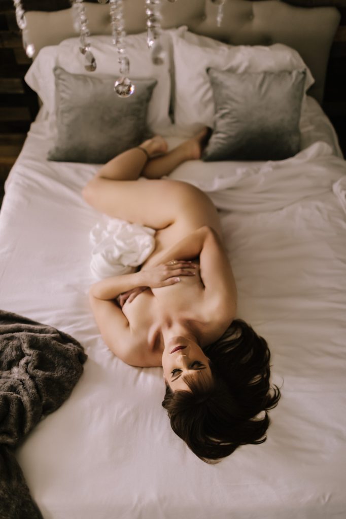 beautiful boudoir photography doylestown pa, nude woman lying on back looking up at camera