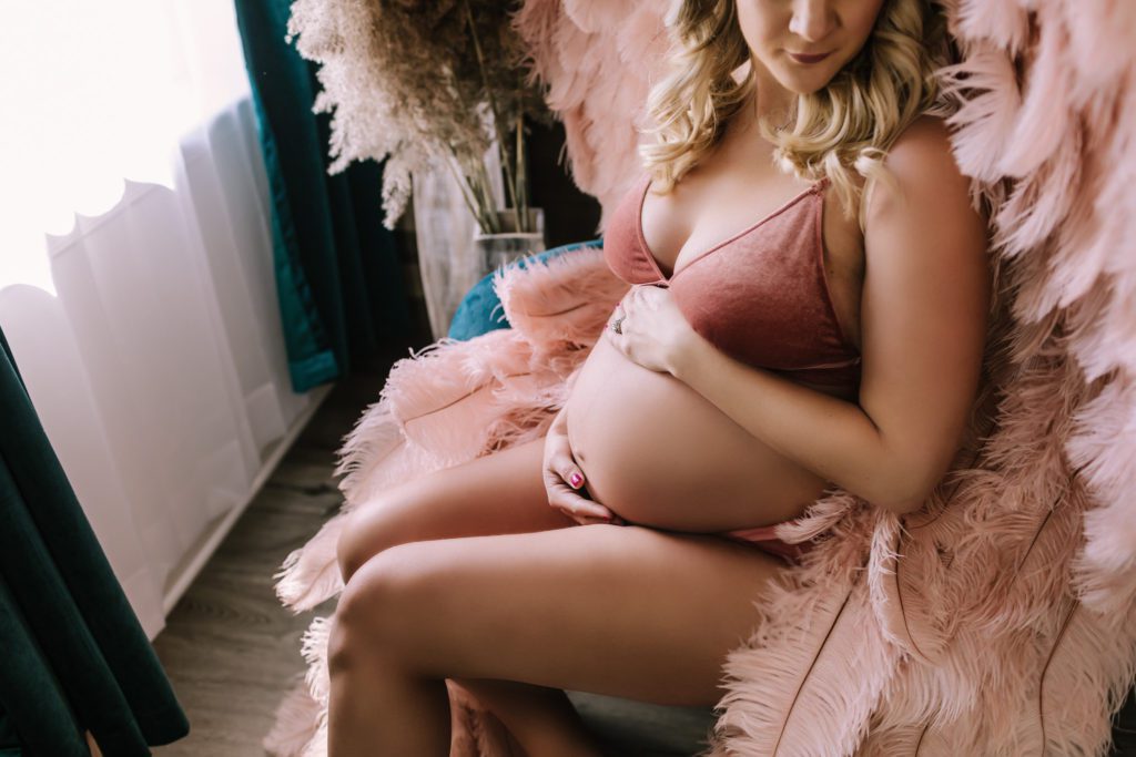 maternity photography doylestown pa, pregnant woman in pink intimate wear with "Victoria's Secret" angel wings