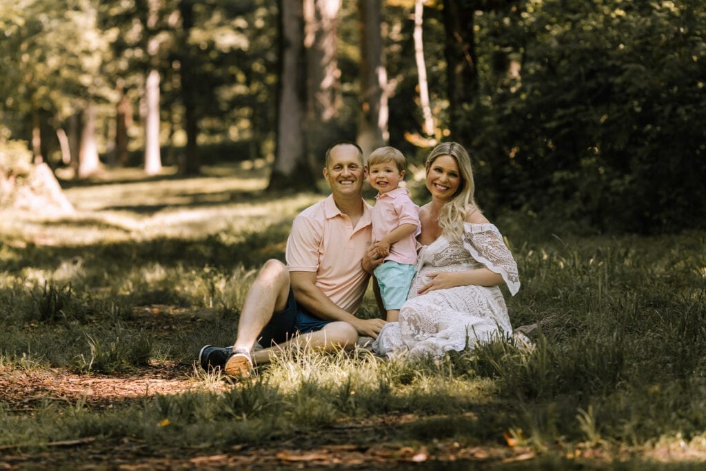 maternity pictures, family sitting outdoors under trees