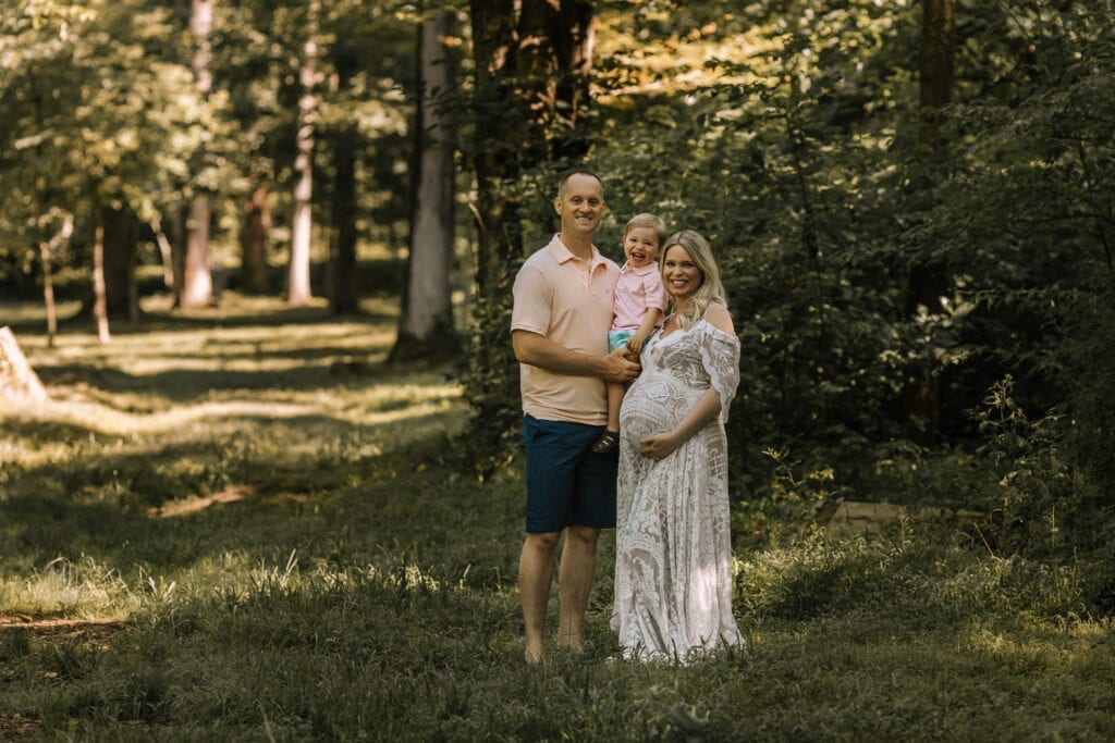 professional maternity pictures pa, family standing in wooded area
