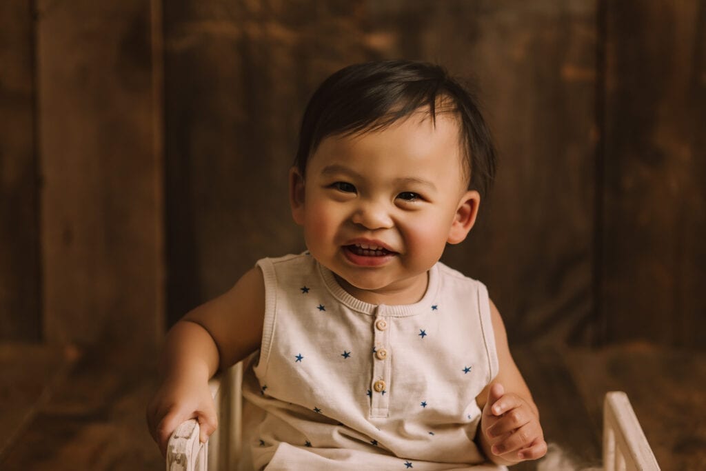 one-year baby pictures, little boy in pjs smiling at camera