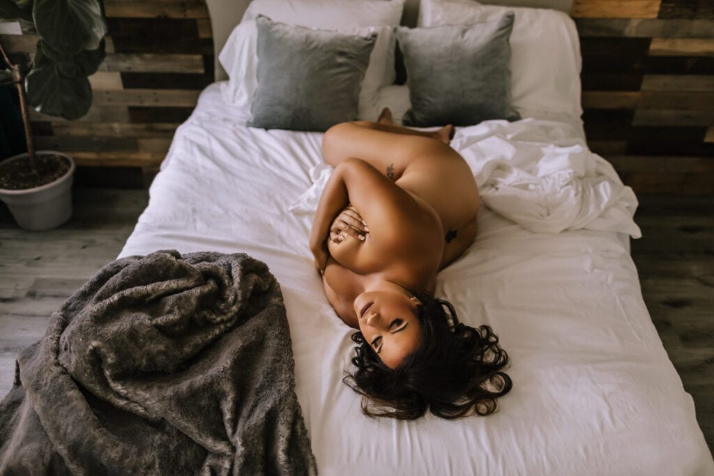 Nude woman lying on bed