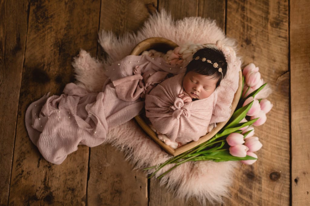 birth announcement photos, baby girl in pink swaddle with tulips