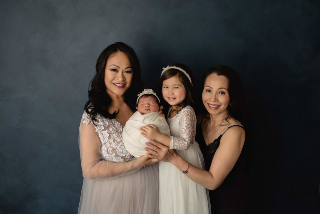 Multi generational family newborn photo shoot portrait style.