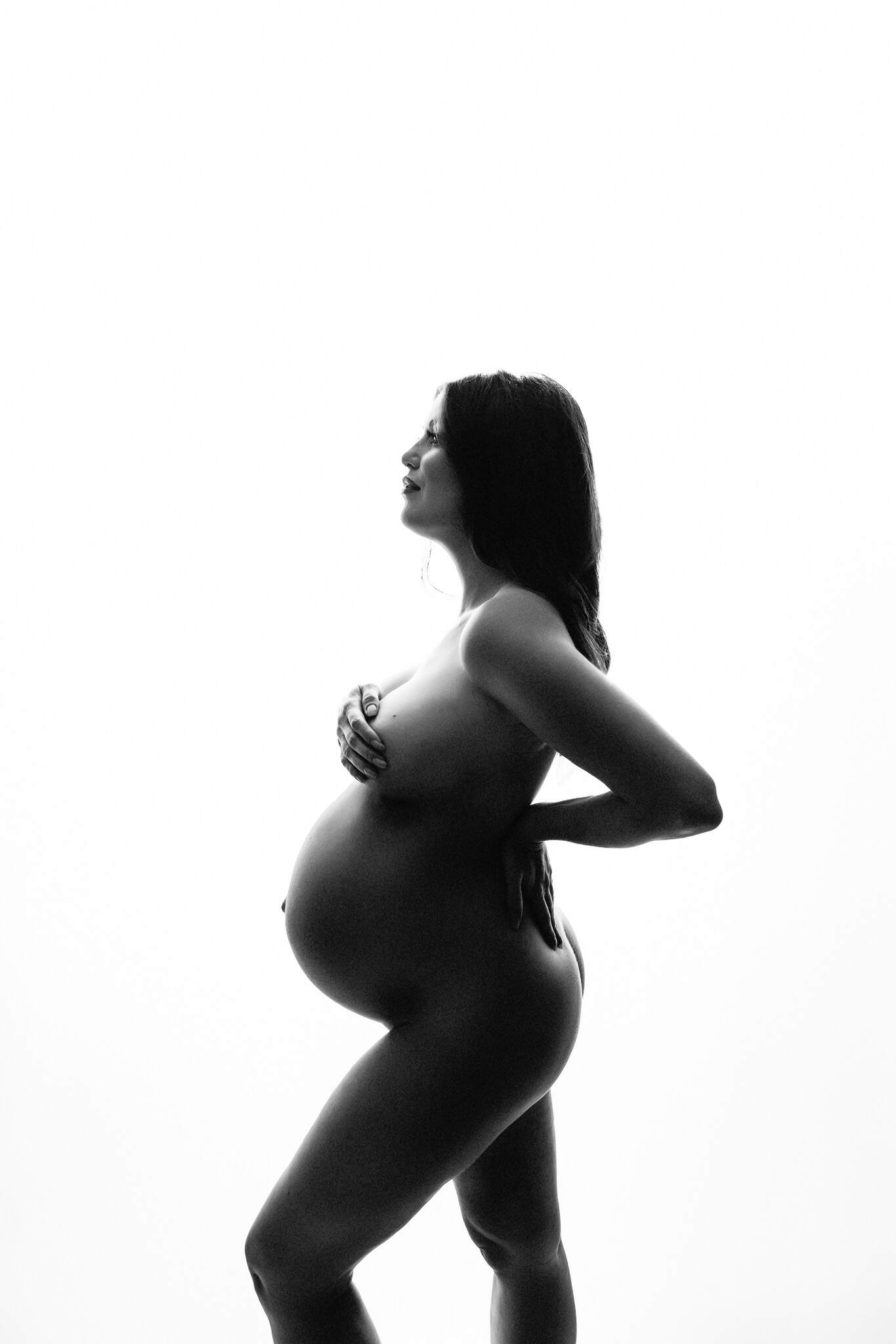 Fine art black and white backlit implied nudity at maternity photoshoot in Pennsylvania.