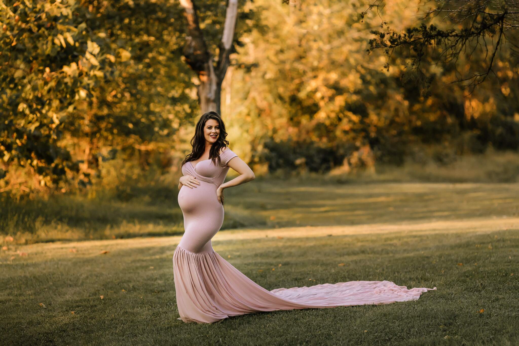 Outdoor maternity photoshoot with dramatic sunset and gowns in Pennsylvania.