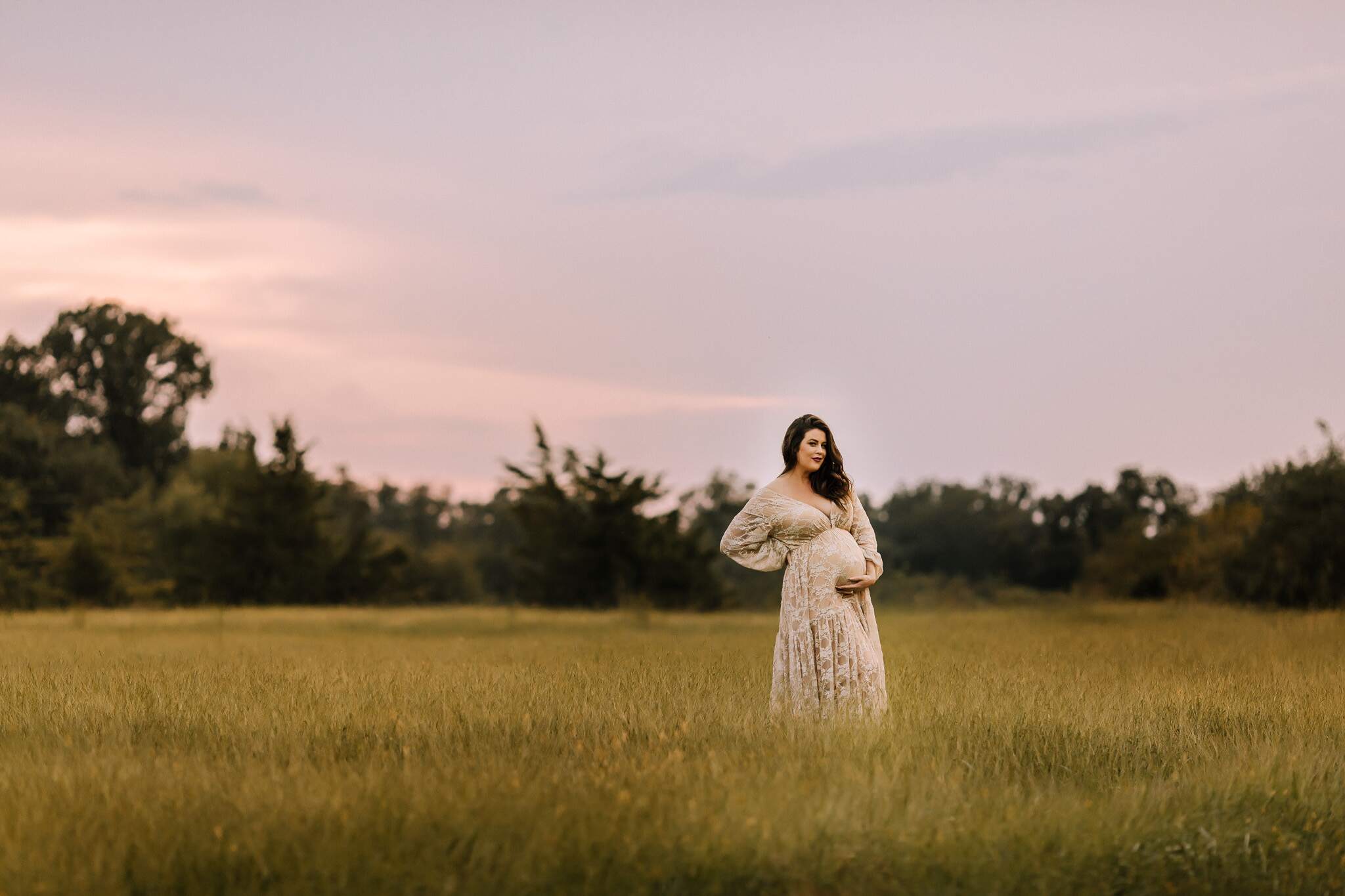 Outdoor maternity photoshoot with dramatic sunset and gowns in Pennsylvania.