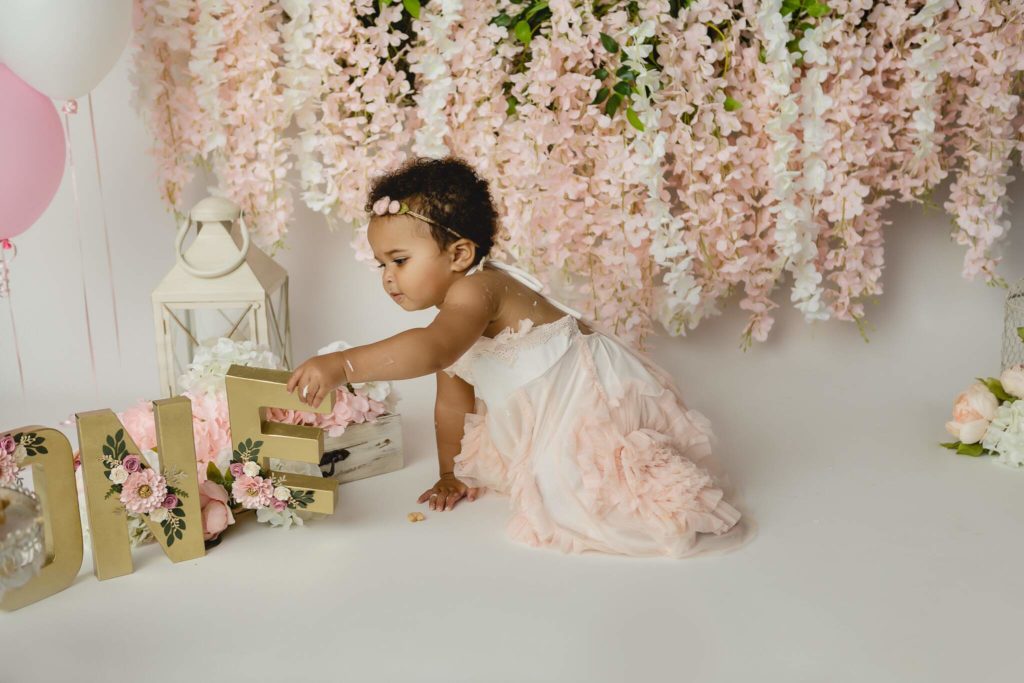 Floral milestone cake smash photoshoot with baby girl