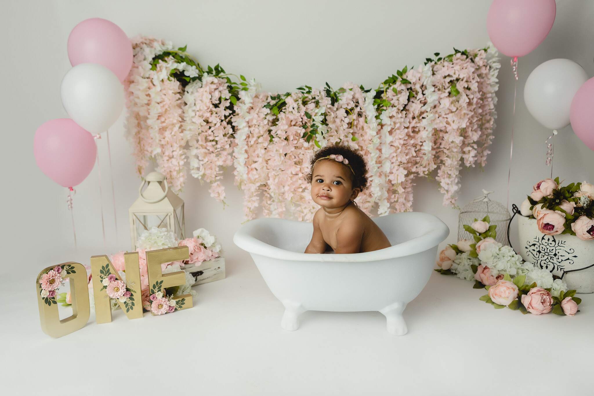 Bath time floral milestone cake smash photoshoot with baby girl