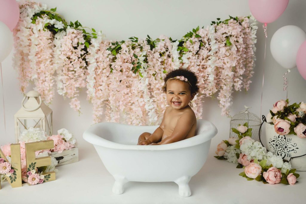 Bath time floral milestone cake smash photoshoot with baby girl