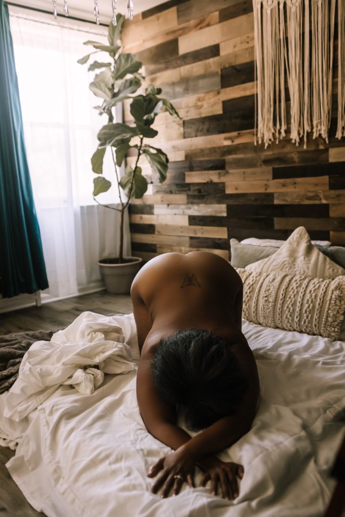 Implied nudity In studio classic beautiful black woman boudoir.